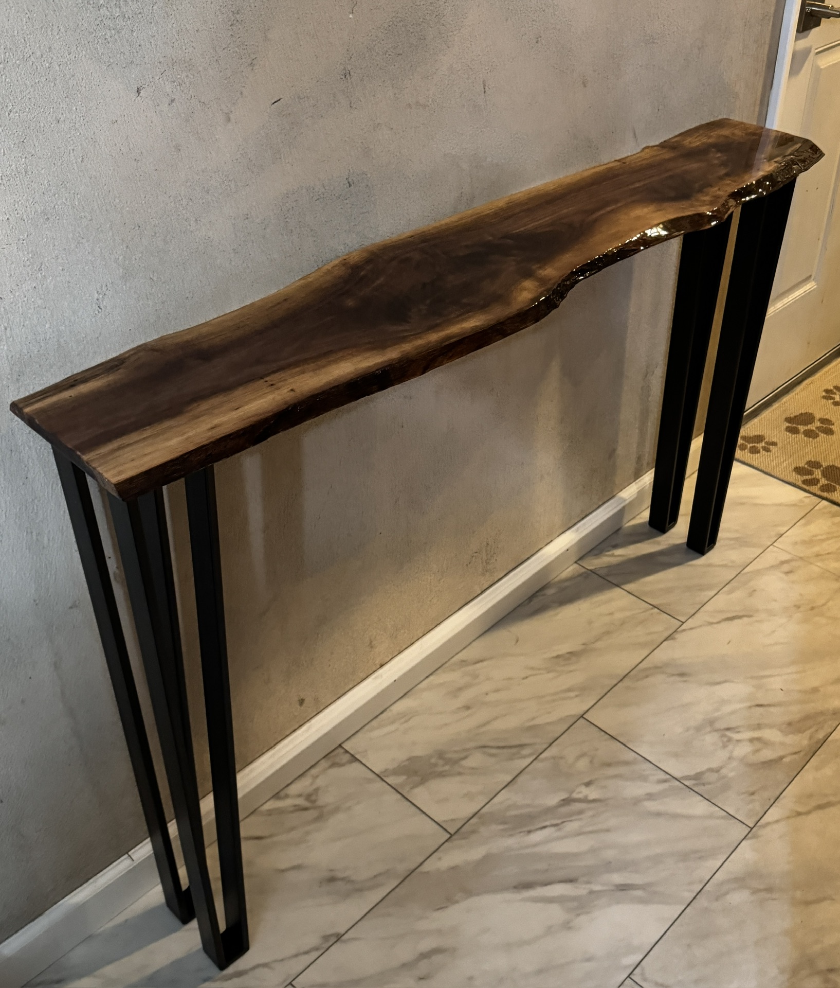 Live-edge hardwood console table with black metal legs